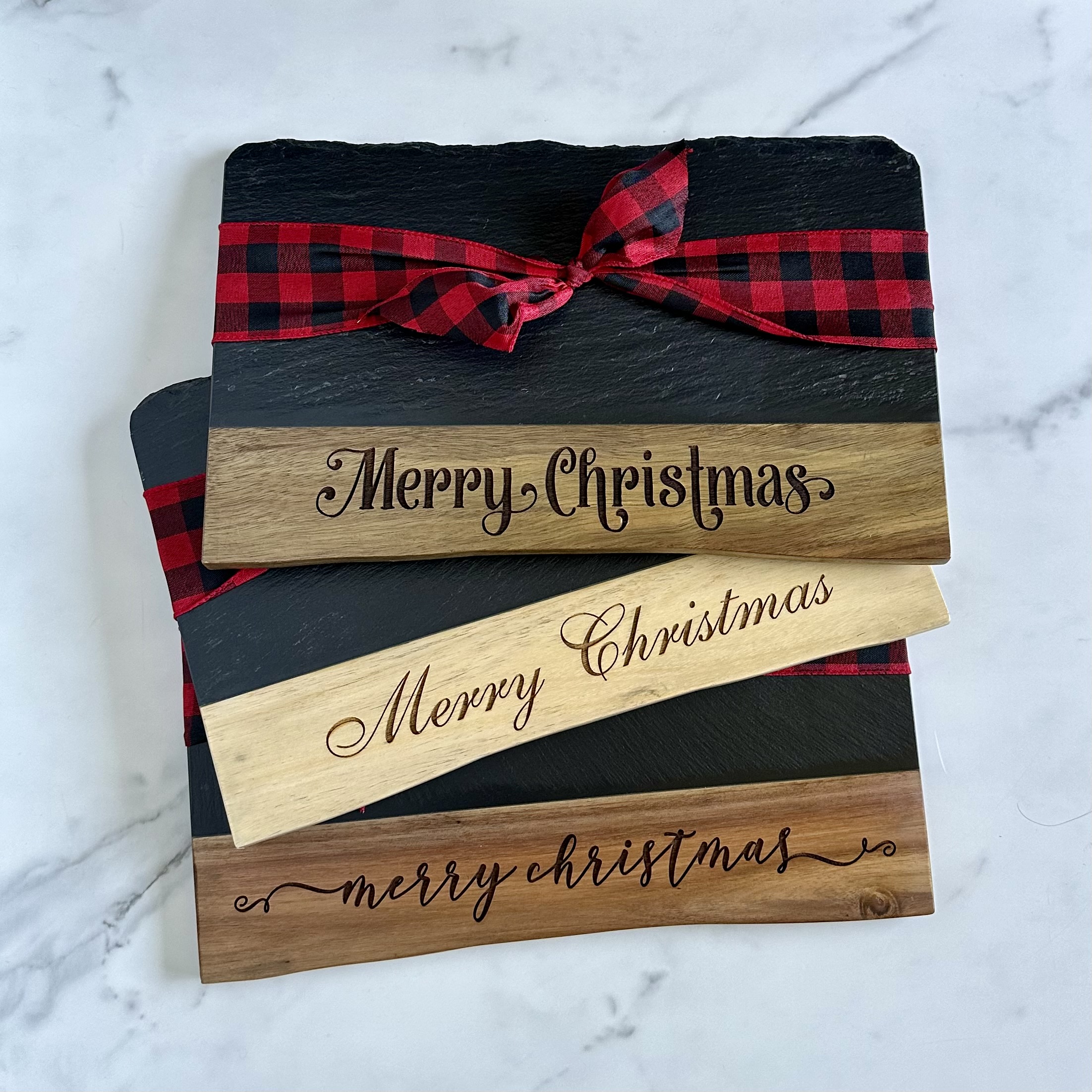Holiday slate and wood boards with festive engravings