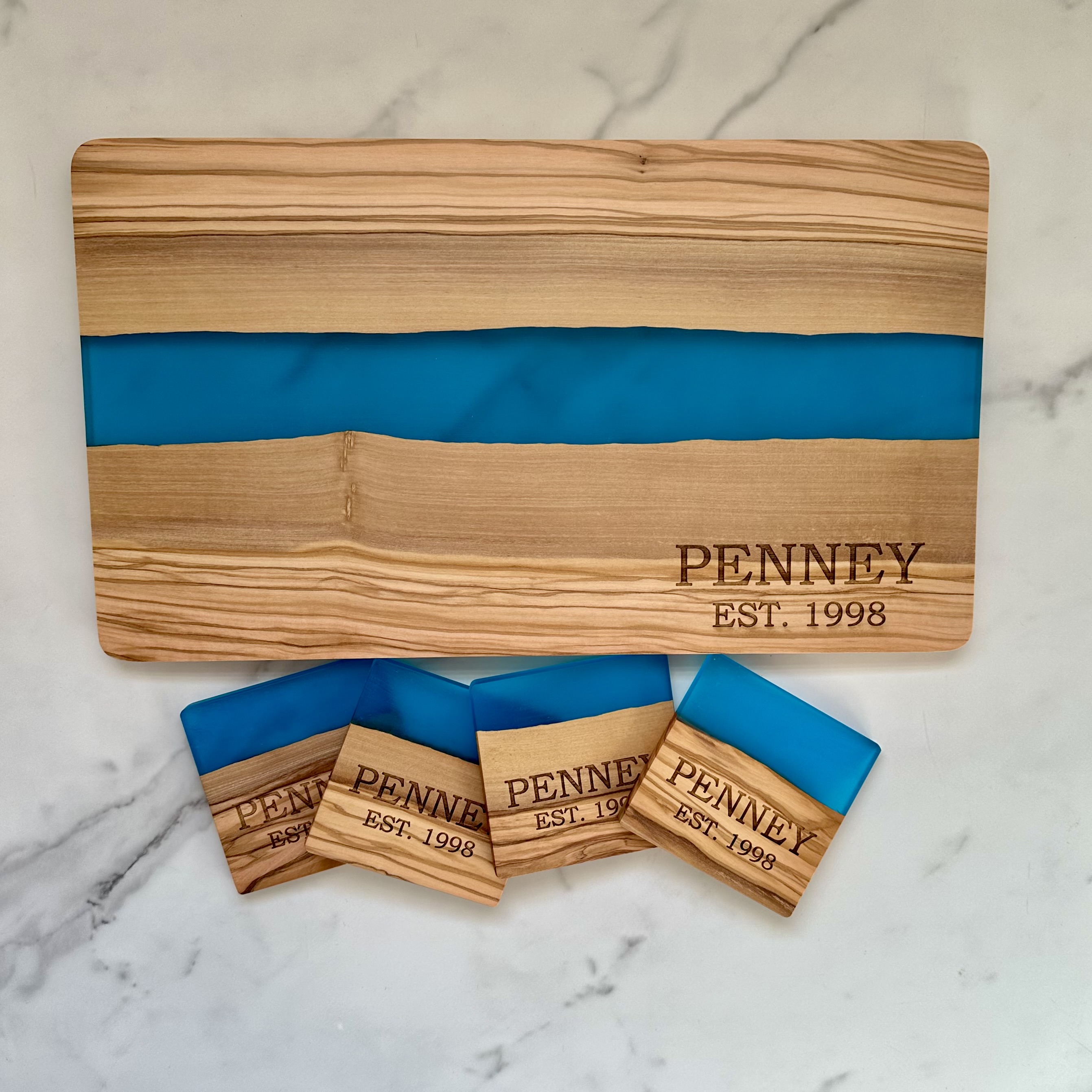 Personalized wood and resin cutting board with matching coasters for weddings and celebrations